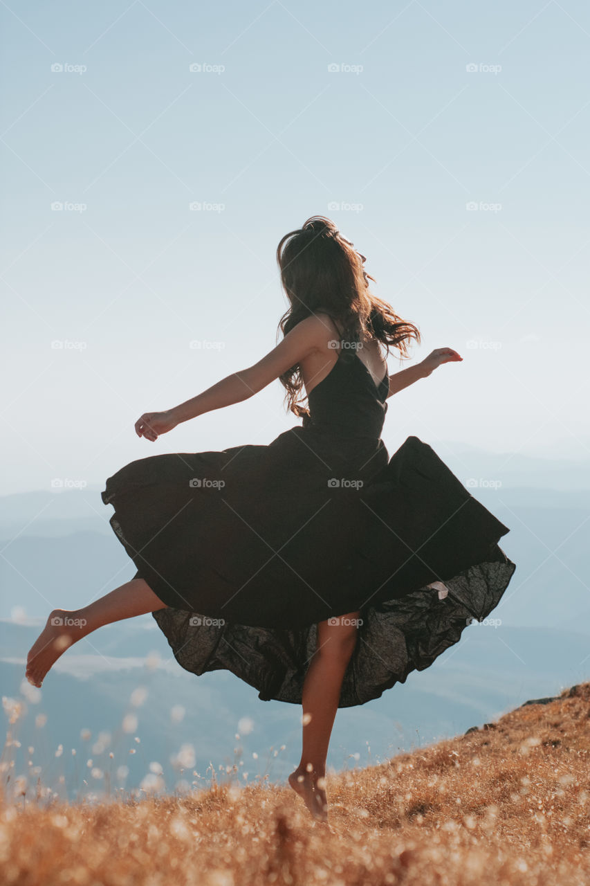 woman dancing in the mountains