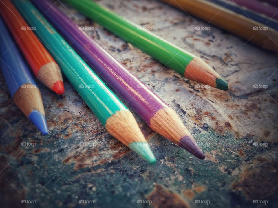 Color pencils against rusty background