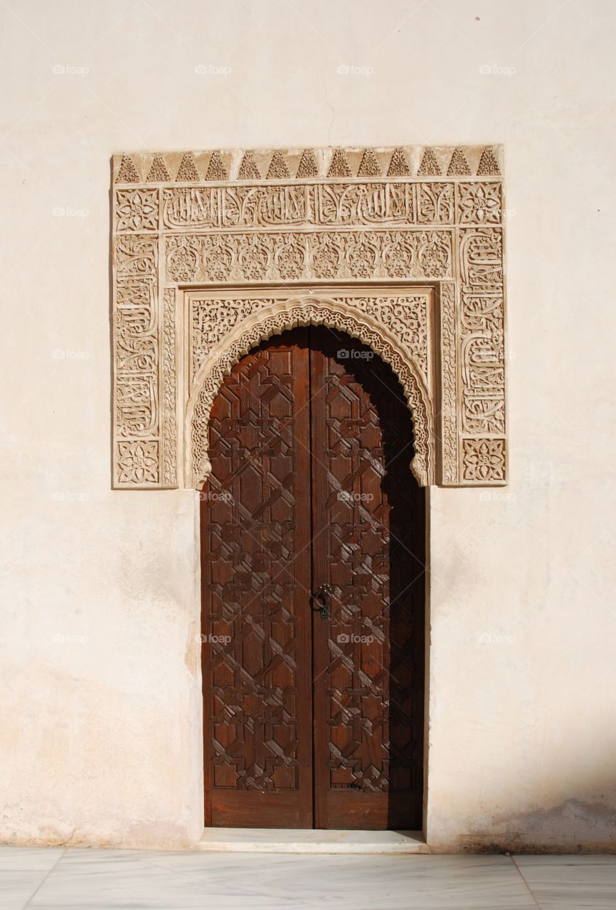 A wooden gate with engraving and decoration in Arabic moorish style