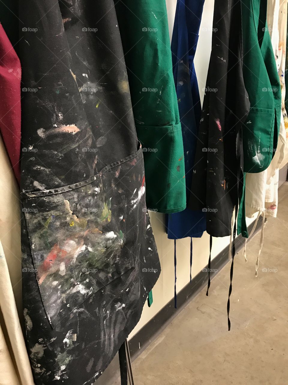 Painting aprons hanging on a wall 