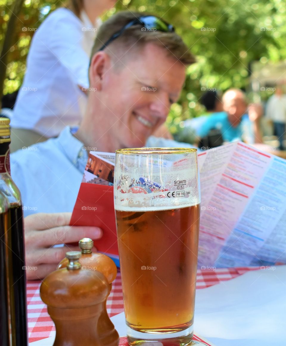 Person looking at menu with a beer