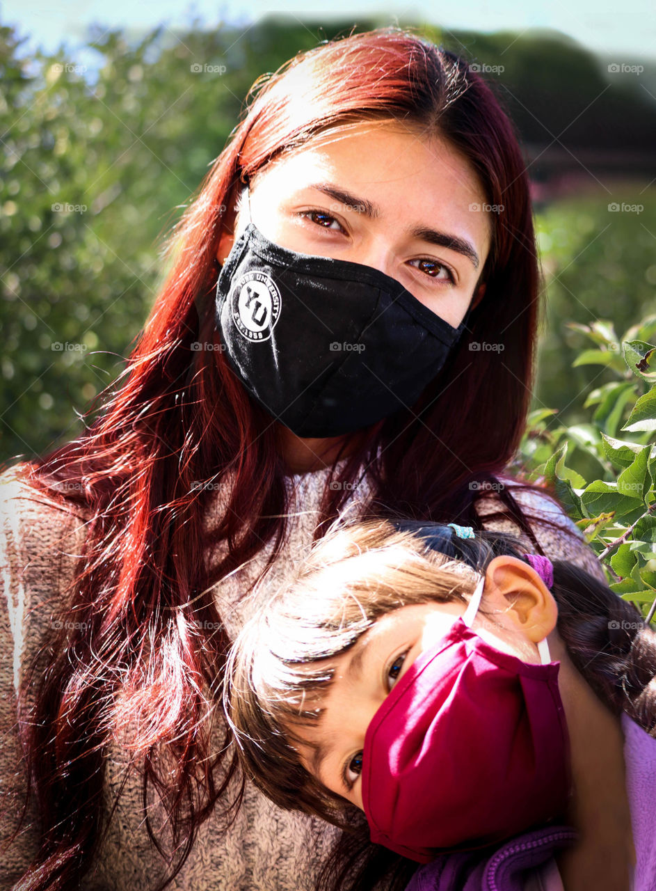 Two girls in face masks