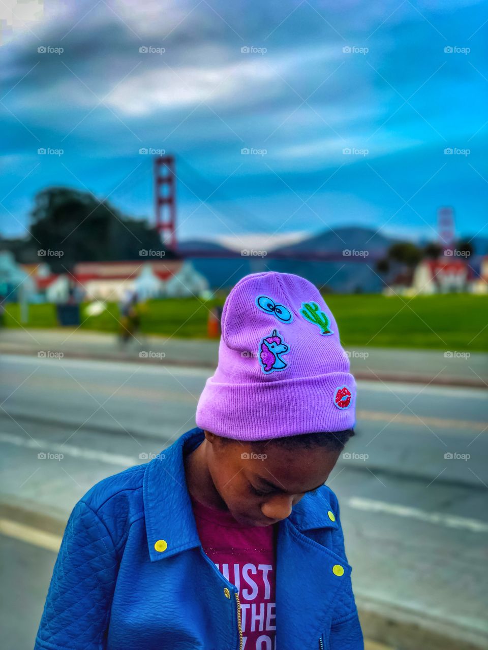 Girl with her head down with the Golden Gate Bridge in the background 