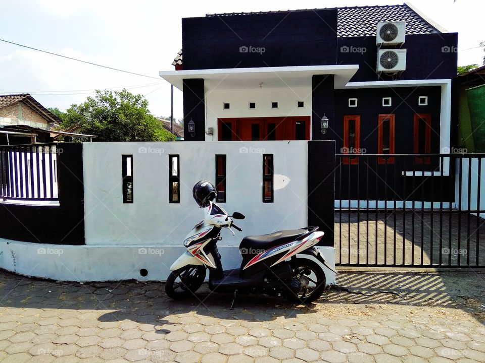 Motorcycle in front of the house