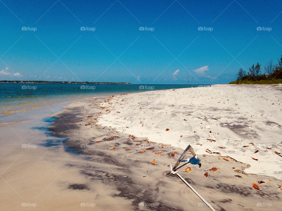 beach sand with an anchor at Ponta do Garcez, coast of Bahia, Brazil 