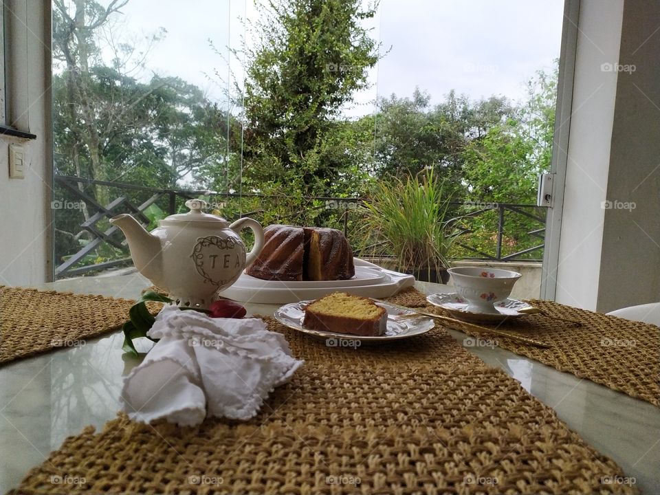 A lovely and delicious peace of cake with a Black coffee in the garden