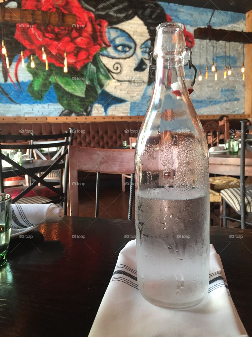 Bottle of water on a table at a restaurant.