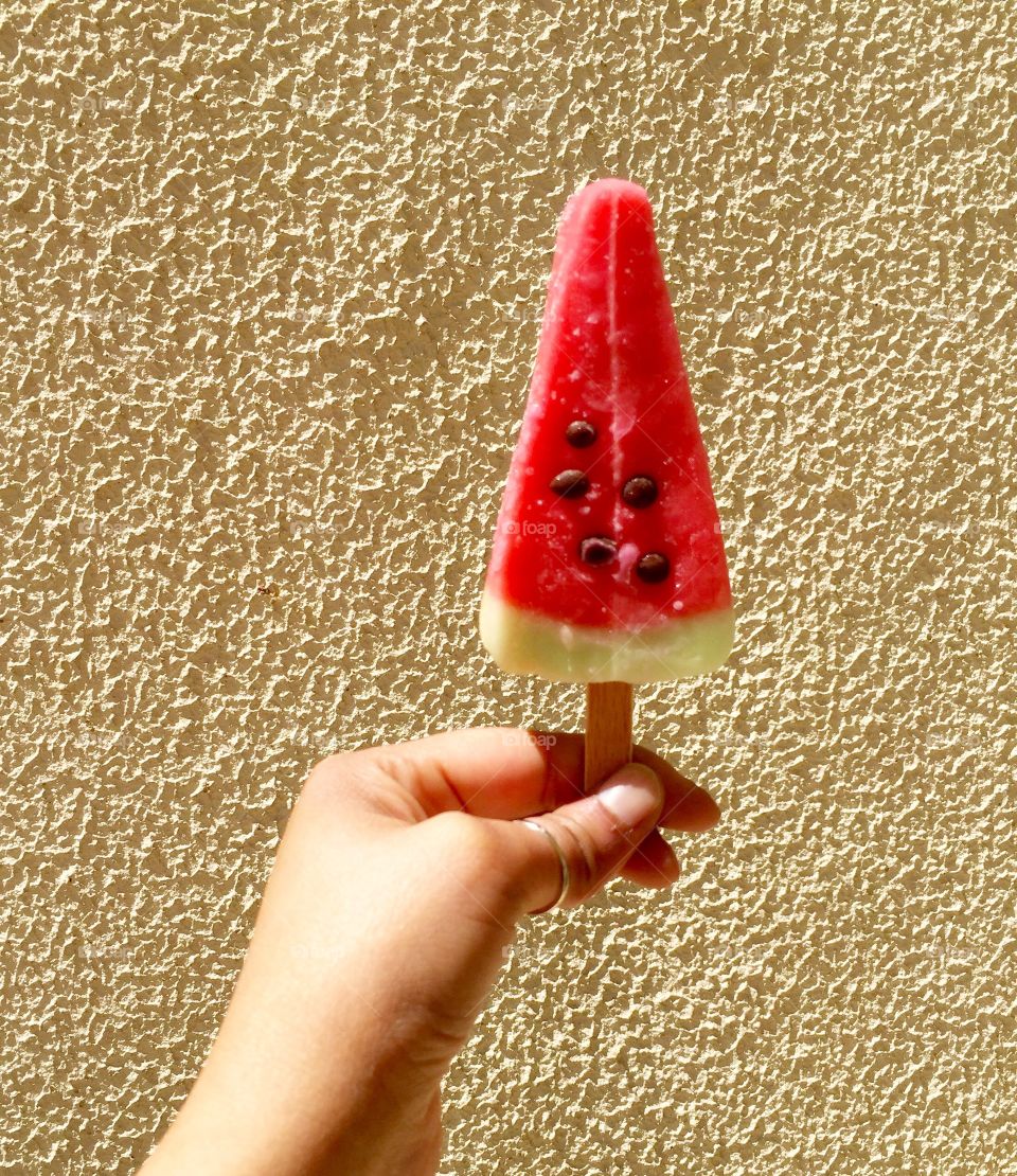 Watermelon ice lolly with beige background 