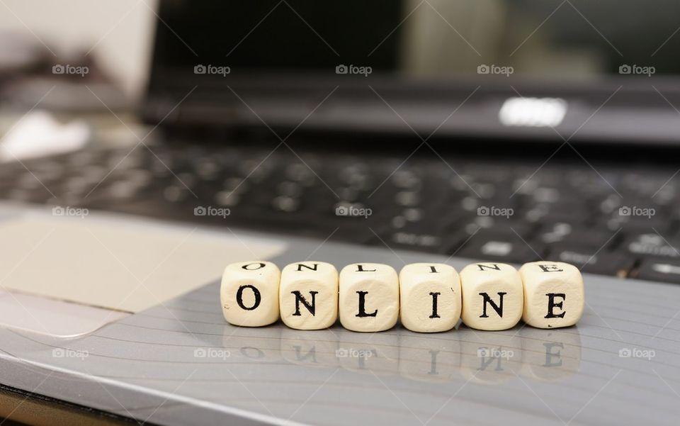 Close-up of dice with laptop