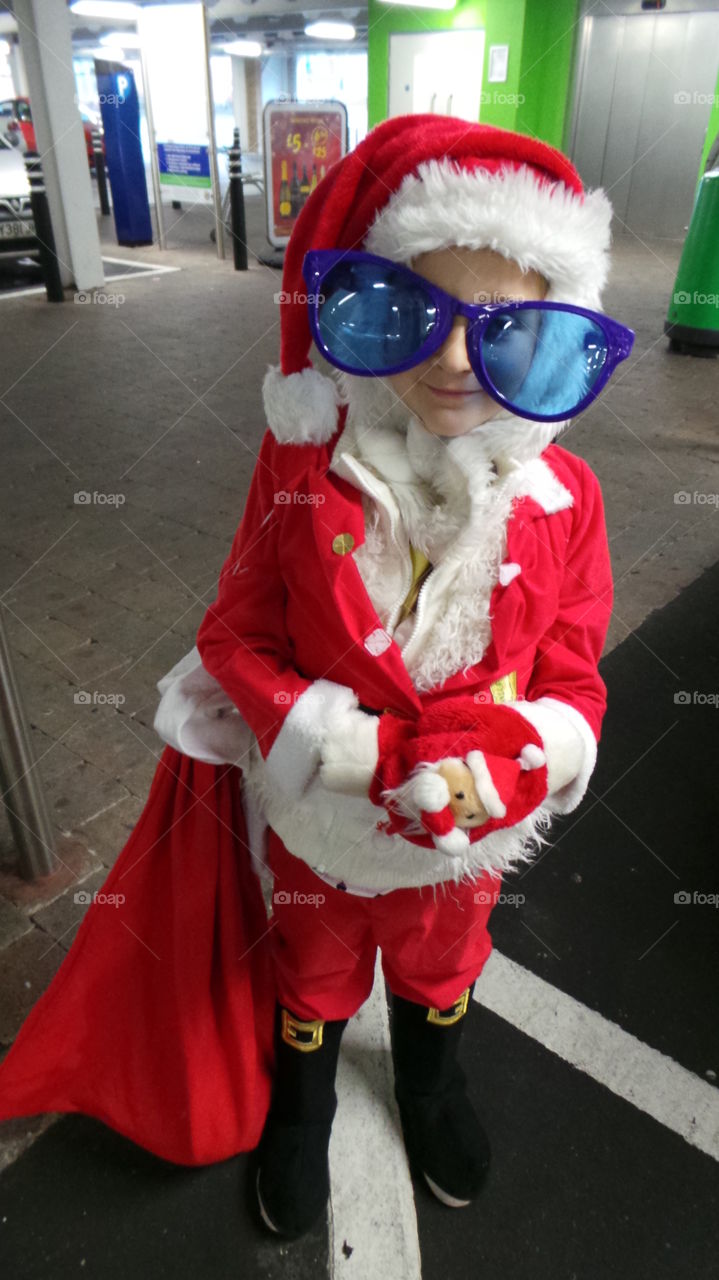 mental jumbo  sunglasses santa clause  costumed child.