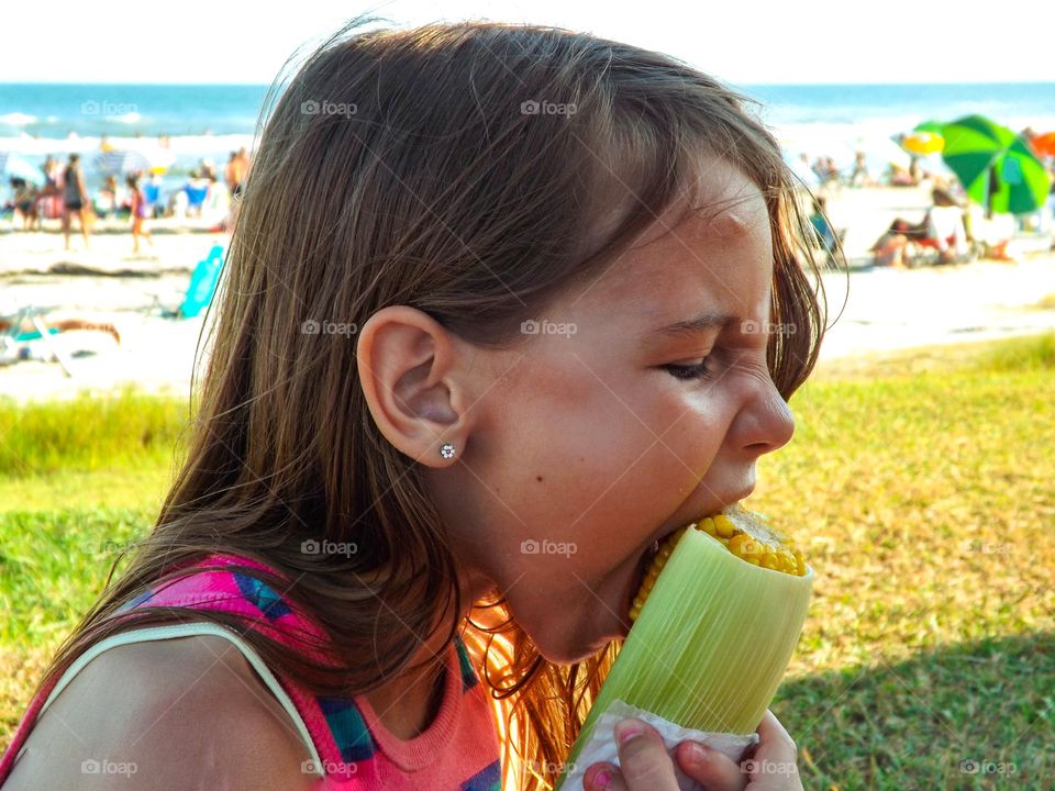 girl eating corn