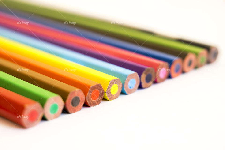 Close-up of colour pencils against white background