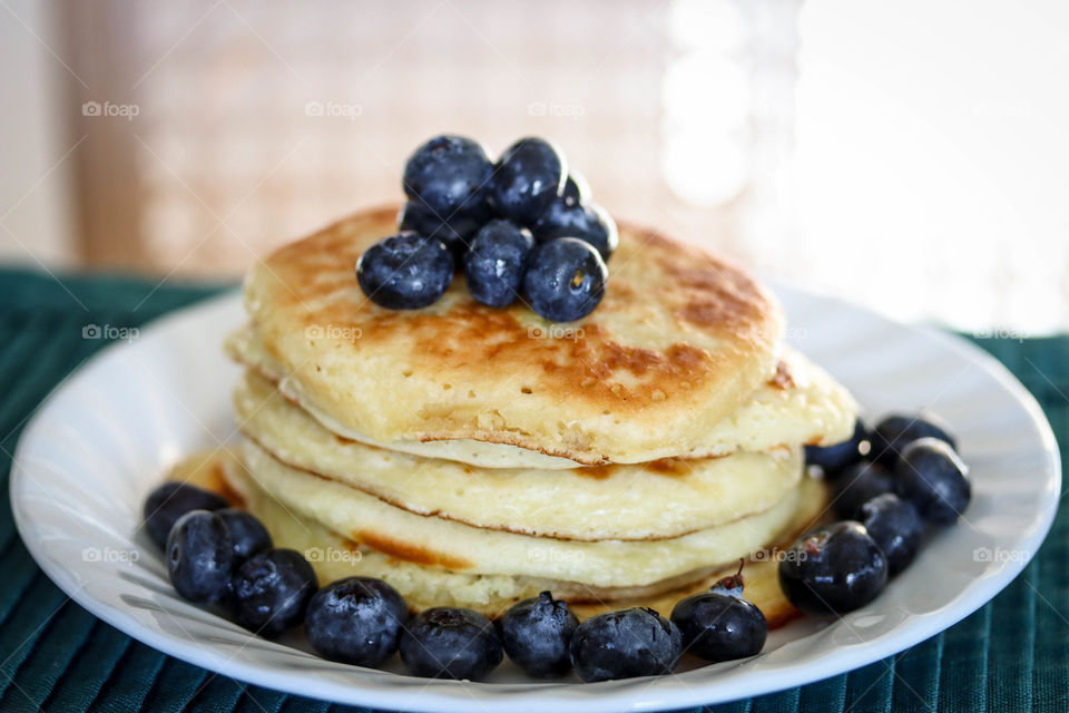 Pile of freshly made golden pancakes on a plate