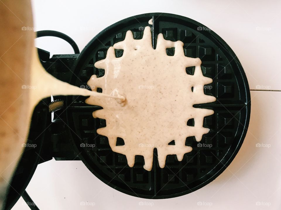 Pouring glutenfree waffle batter