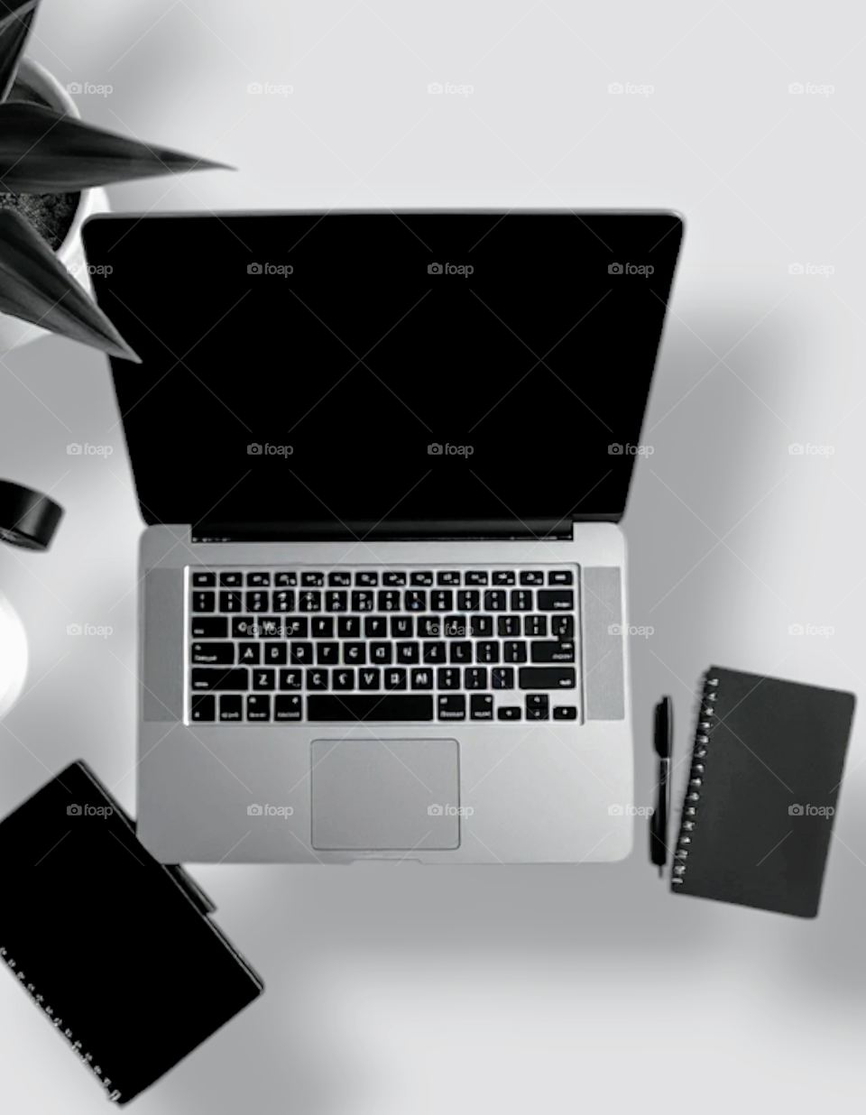 A desk for working  with a tablet and notebooks