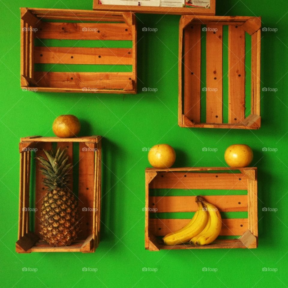 Fruits shelves in green wall