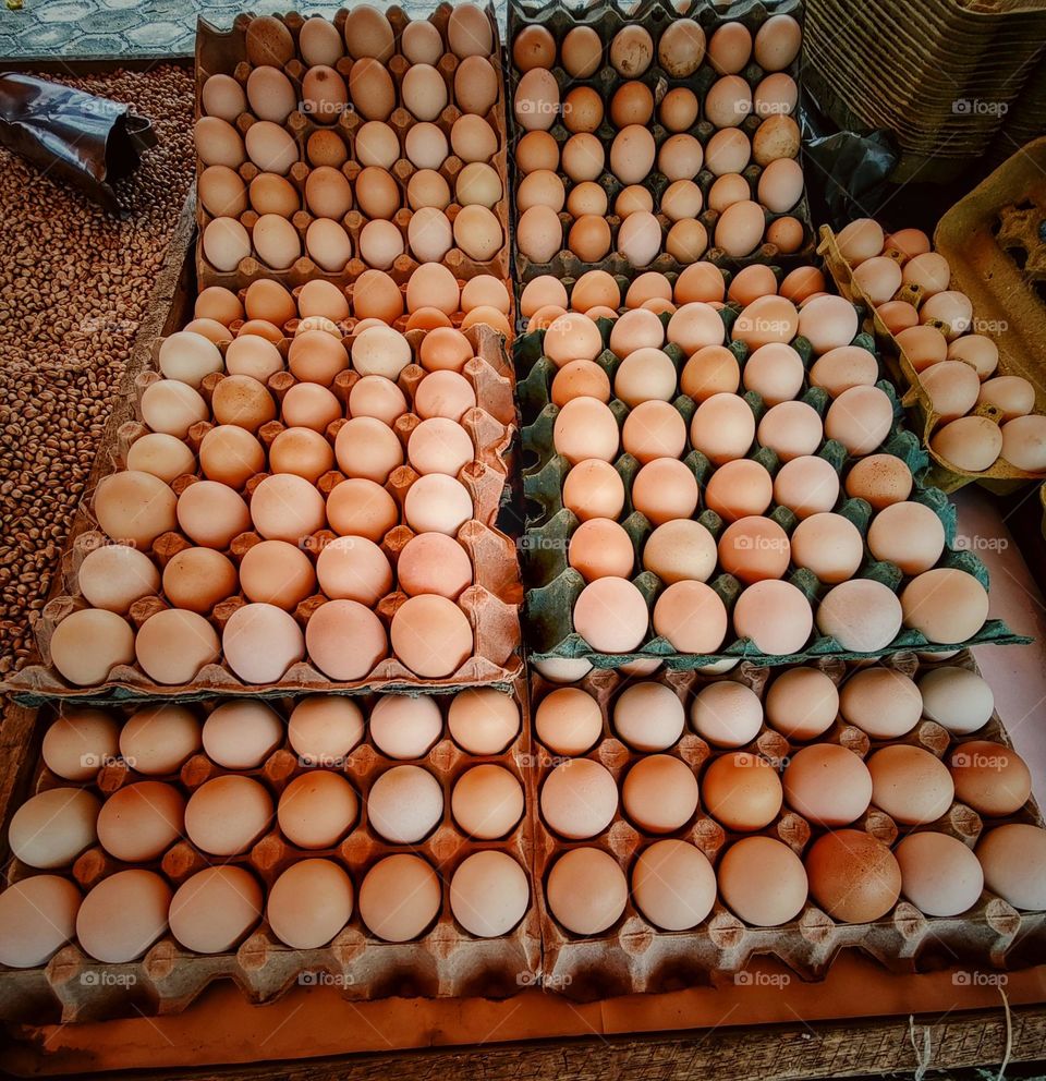 free-range chicken eggs are sold at the market stall