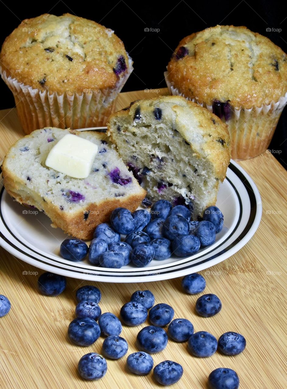 Blueberry muffins with butter and fresh blueberries 