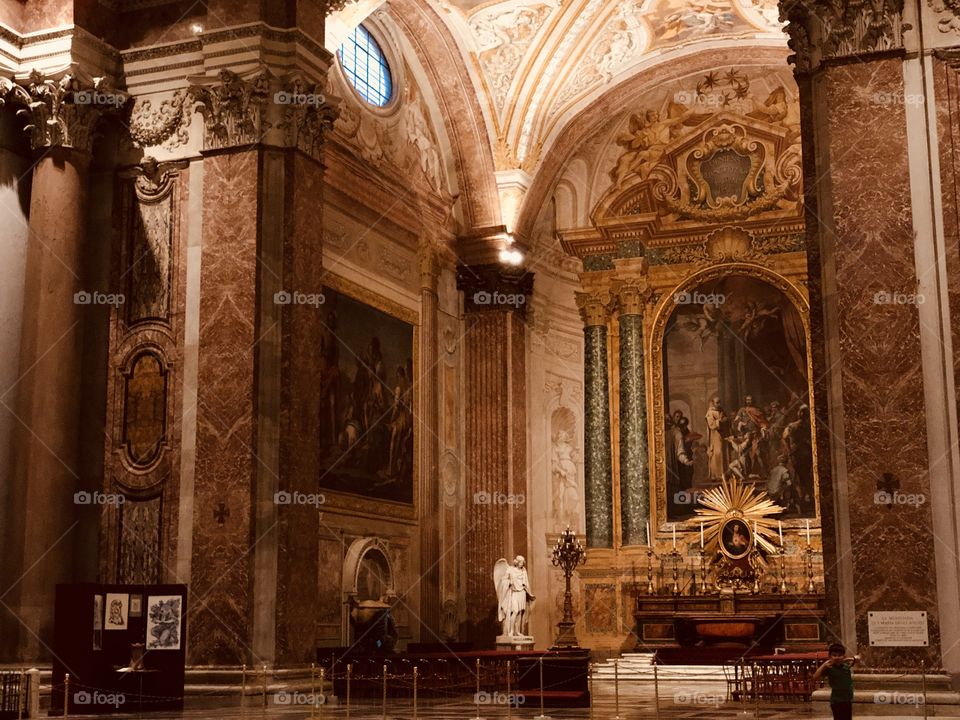 Another inside of a church in Rome, a warmly lit church with beautiful wall decor 