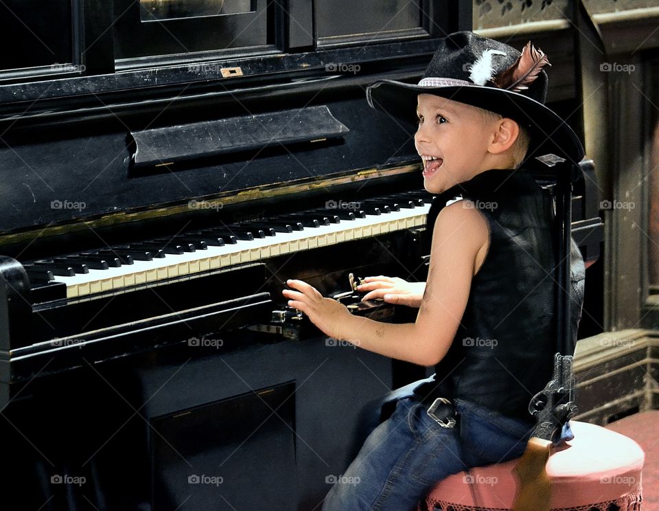 Playing piano. A boy playing the piano