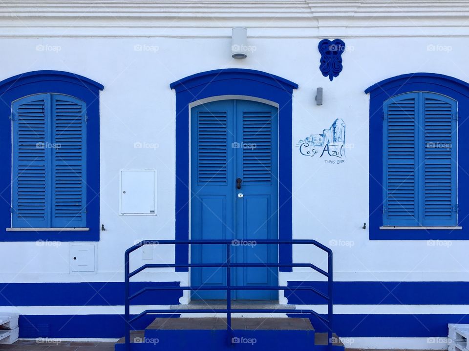 Blue windows and door with shutters 