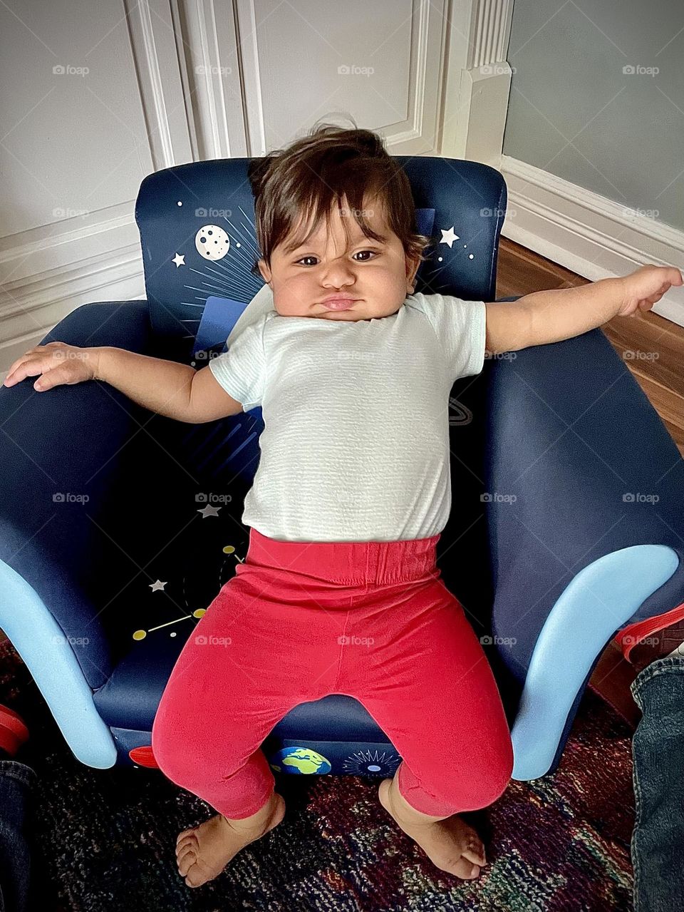 Baby girl is disgusted with seat, baby girl with look of disgust on face, facial expression of disgust, disgusted baby, baby shows emotion of disgust, facial expressions of a human