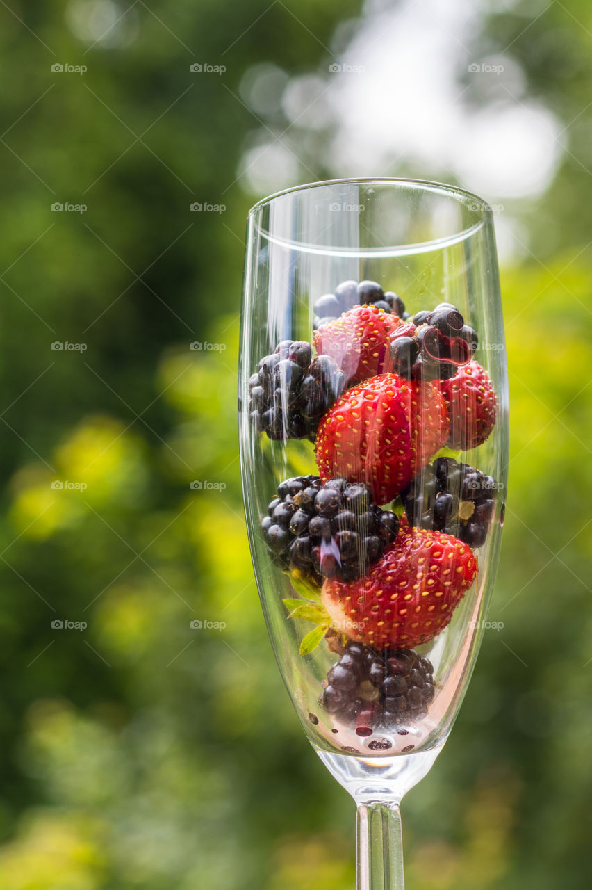 Colorful berries in a champagne glass