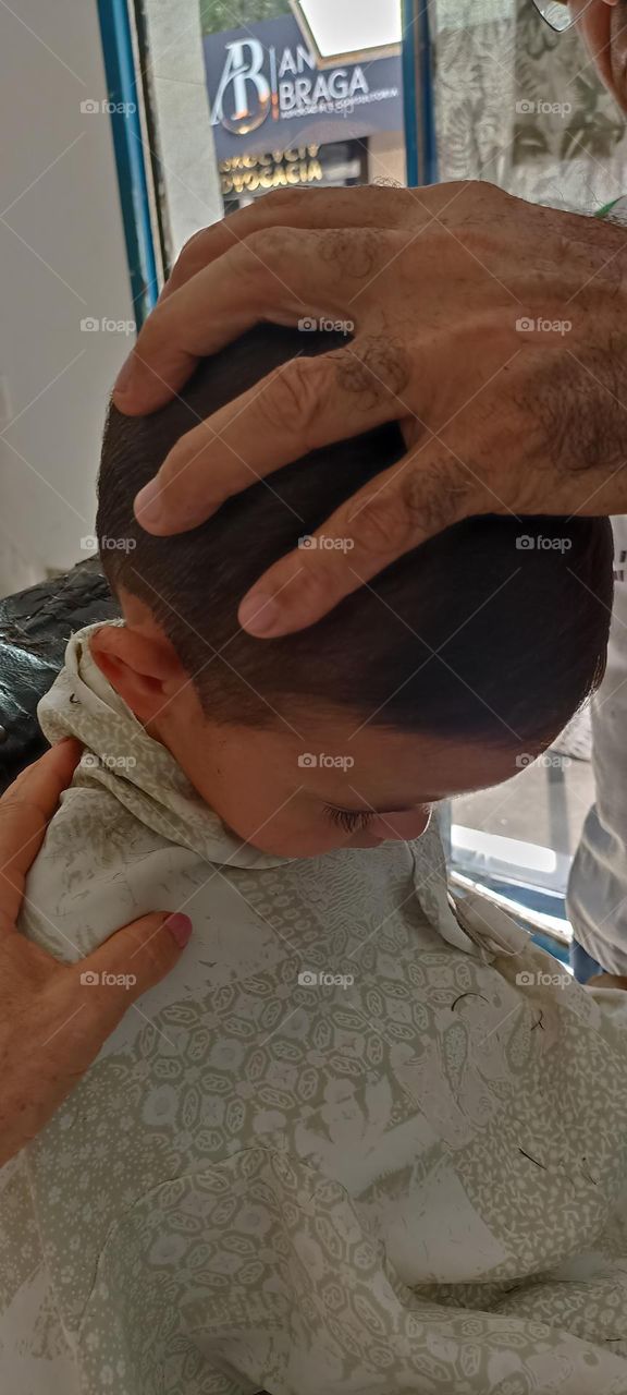 Boy falls asleep while cutting his hair