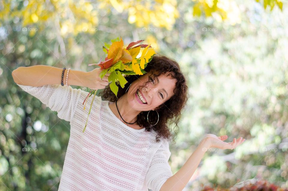 Happy Young Woman on Autumn Background