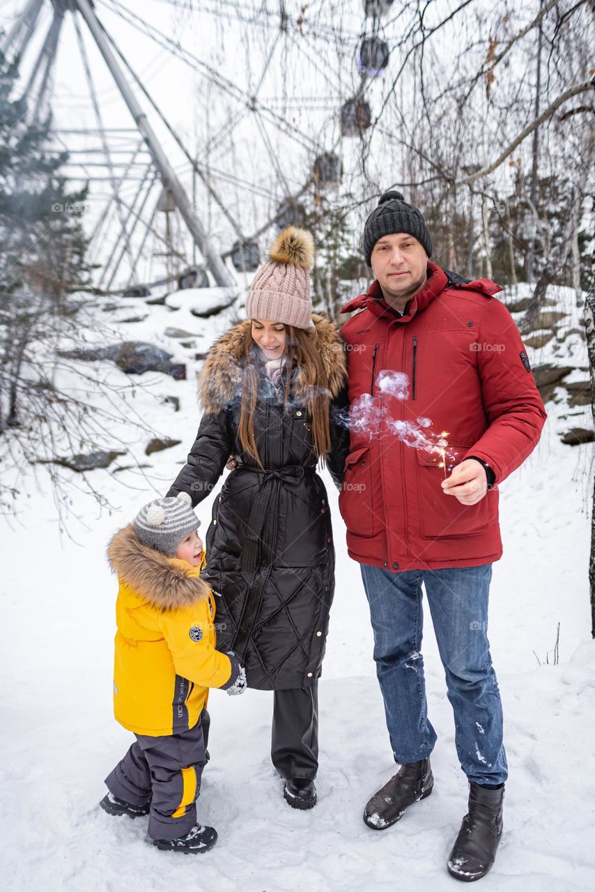 Happy family in park winter season 