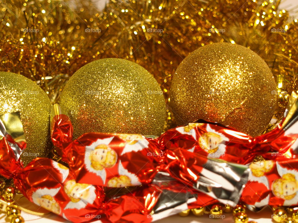 Holidays background with tinsels, ball decorations, beadwork and hungarian christmas candy.