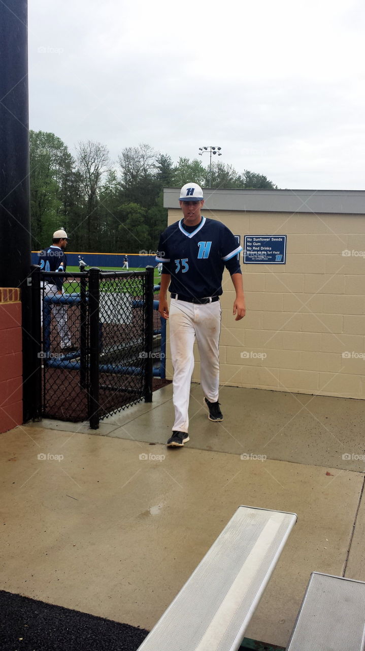 wet baseball player. rainy day baseball game