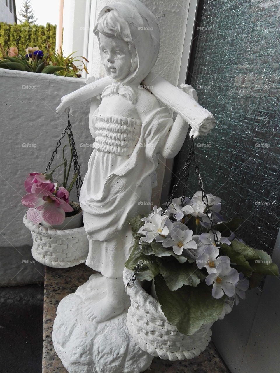 statue with flowers in pots