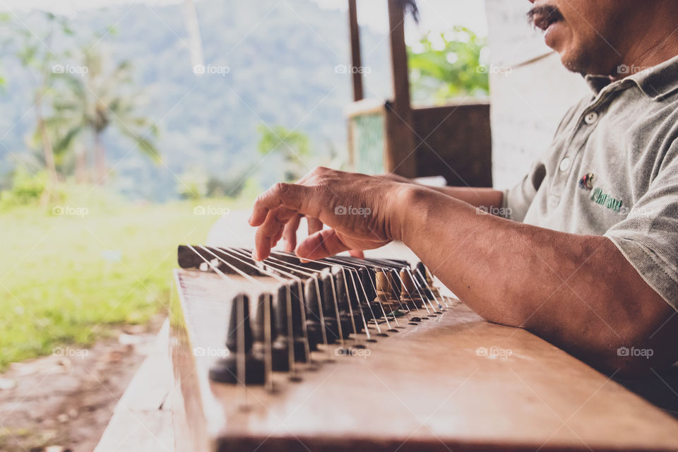 The music device is called Kecapi, the original and traditional music of sundanese people from west java Indonesia