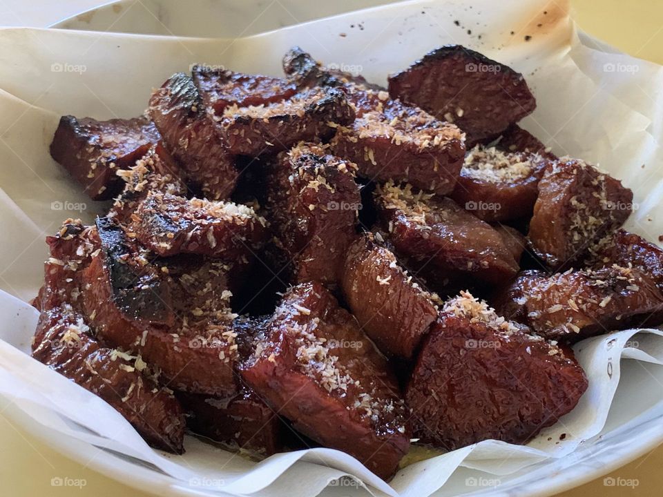 Sweet potato fried in oil and coconut sugar with sprinkled grated coconut. 