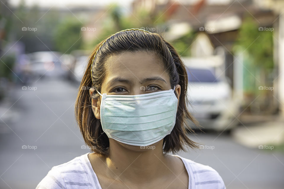 Asean Woman wear a mask to prevent dust in Bangkok ,Thailand.