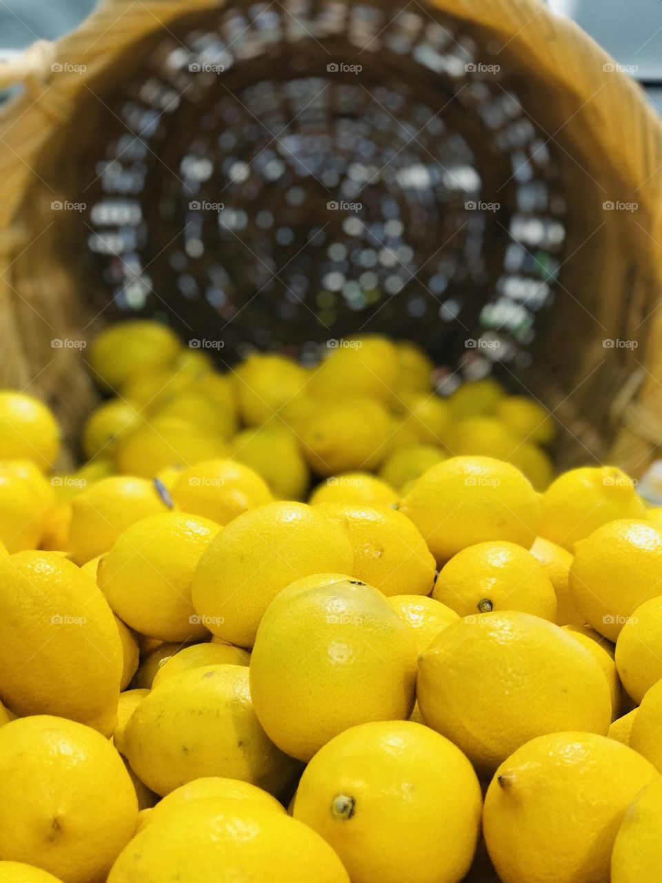 Fresh lemons filled and flattened in bamboo basket.