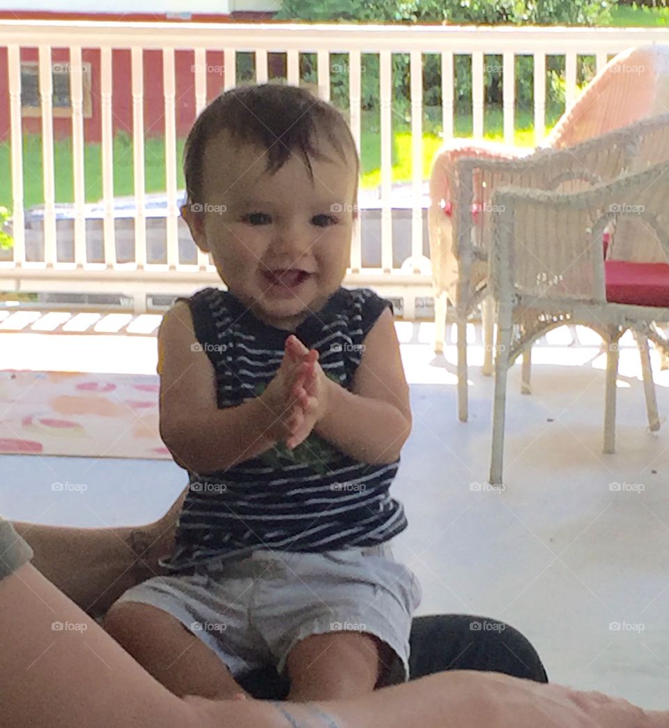 Baby boy clapping hands in delight to our singing to him.