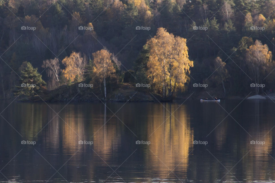 Colorful Autumn - canoeing on a calm lake - reflection 