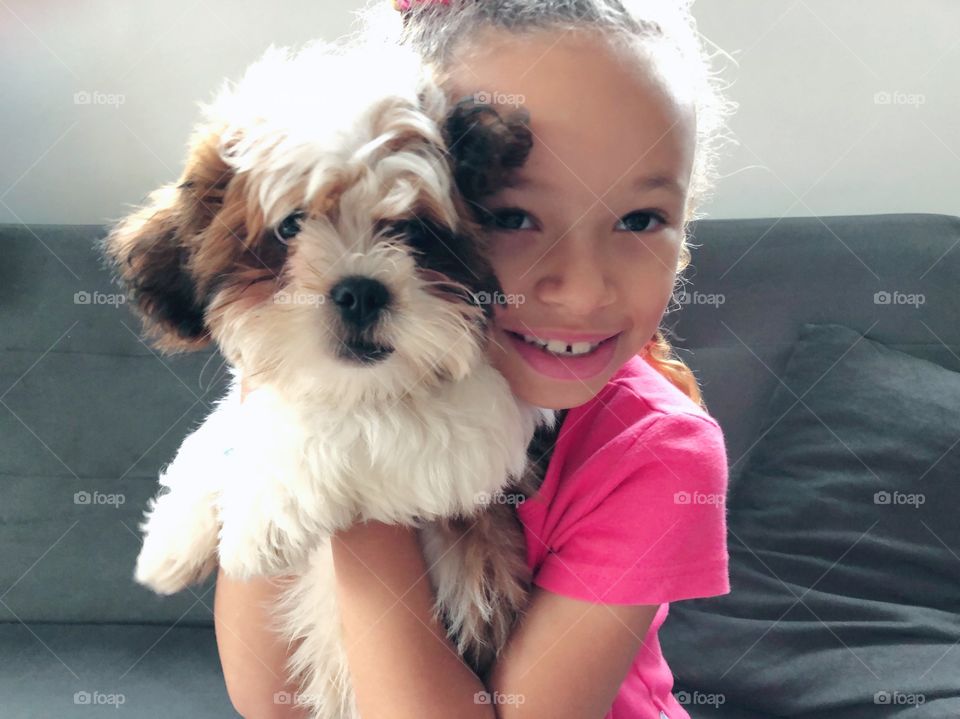 Little girl holding a puppy
