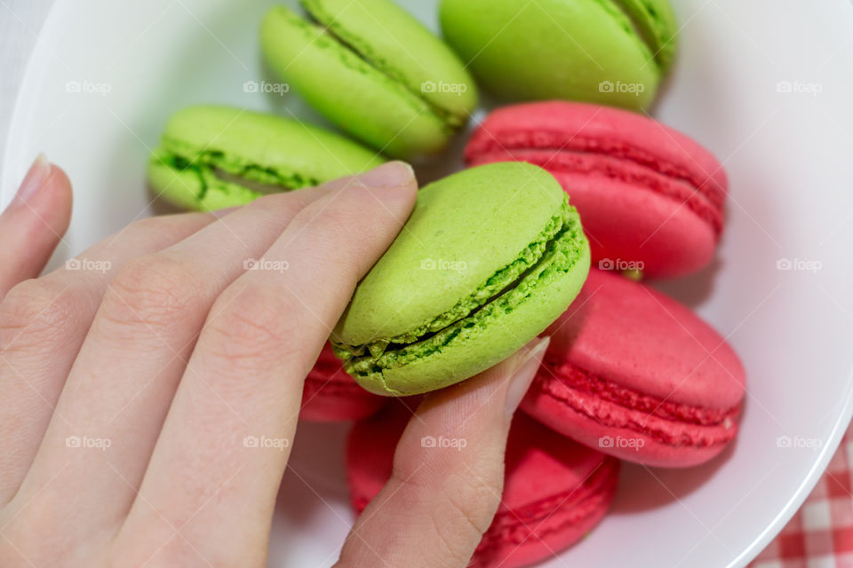 Close-up of macaroon in hand
