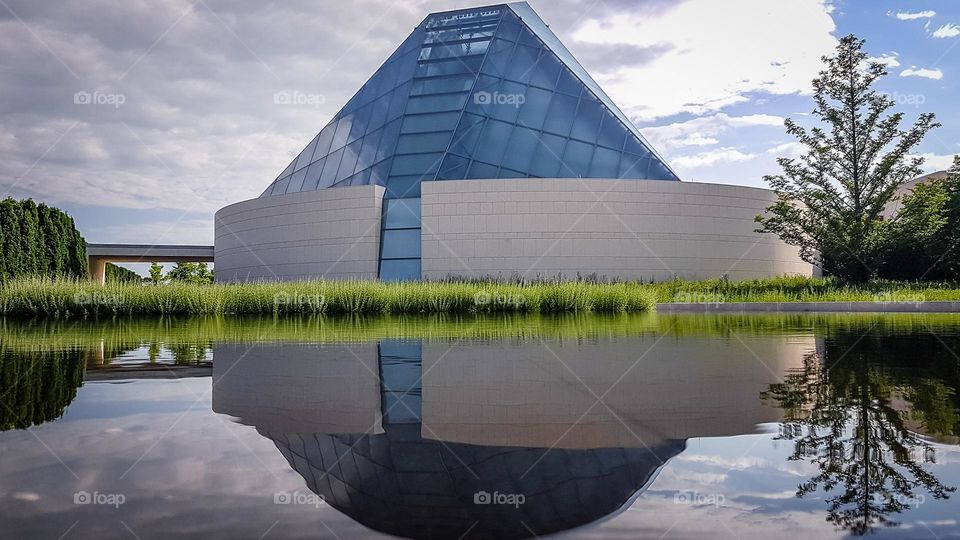 Modern building reflecting in a water pool