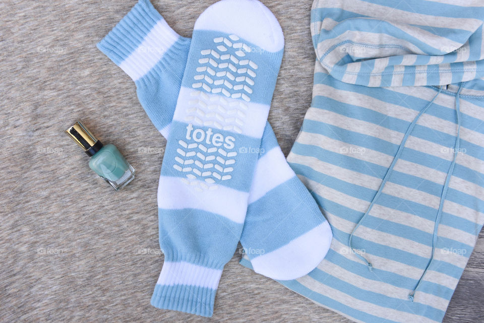 Flat lay of blue striped slipper socks with other blue items