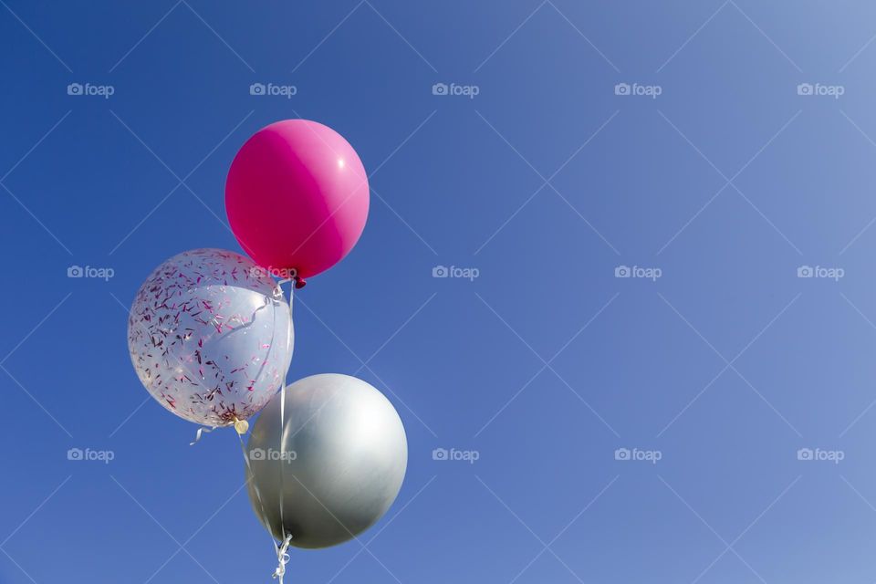 Helium birthday balloons in the sky