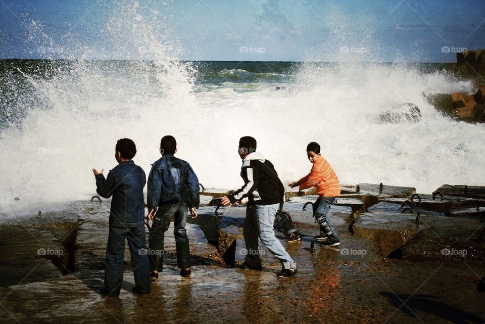 Children playing with the break waves