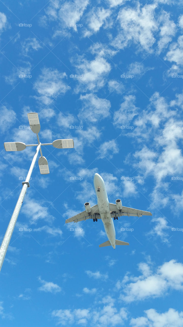 up in the sky. Waiting at the airport parking lot. Plane comes by every 5 minutes