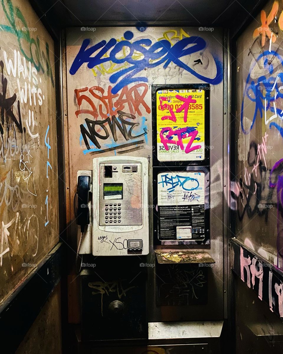 Graffiti covered phone box