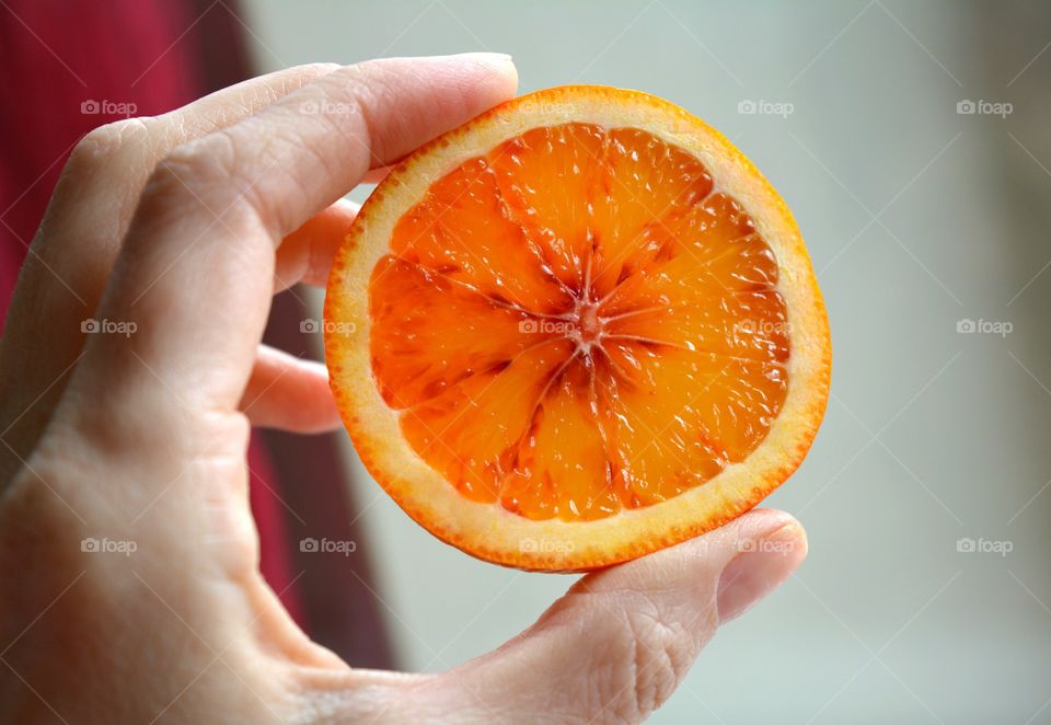 orange citrus sliced fruit in the female hand texture background