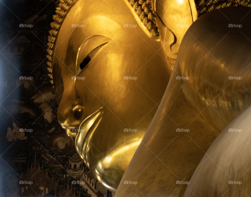 Beautiful face of The big Reclining Buddha at Wat Pho ,the Temple of  the Reclining Buddha Bangkok Thailand