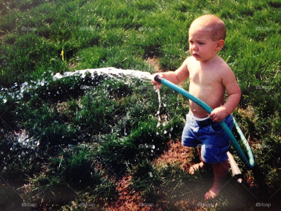Boy holding water pipe in hand